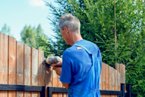 Man schneidet Gartenzaun mit Stichsäge